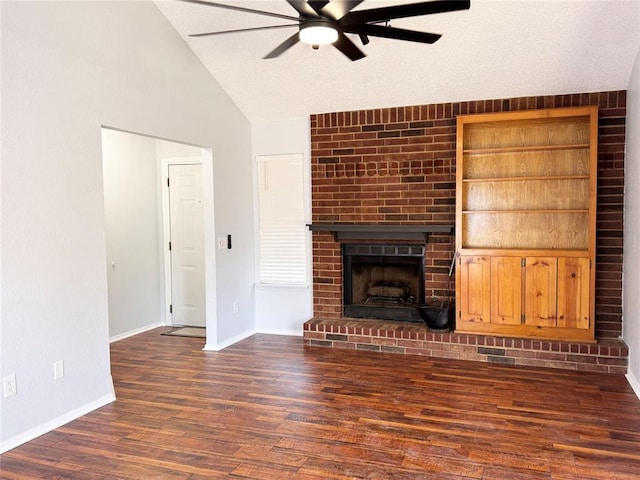 unfurnished living room featuring a fireplace, a ceiling fan, vaulted ceiling, wood finished floors, and baseboards