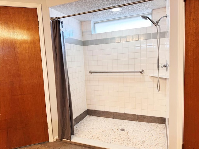 full bath featuring a stall shower and a textured ceiling