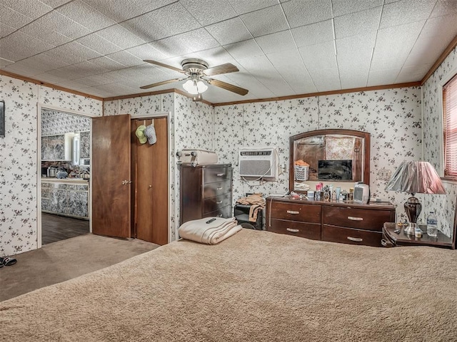 bedroom featuring carpet floors, a ceiling fan, ornamental molding, a wall mounted air conditioner, and wallpapered walls