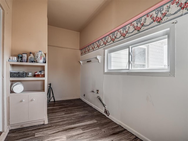 laundry room featuring laundry area, dark wood-style flooring, and baseboards