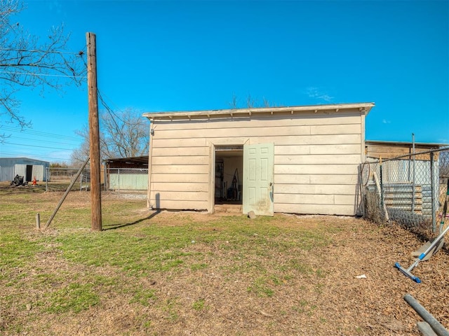 view of outbuilding with an outbuilding and fence