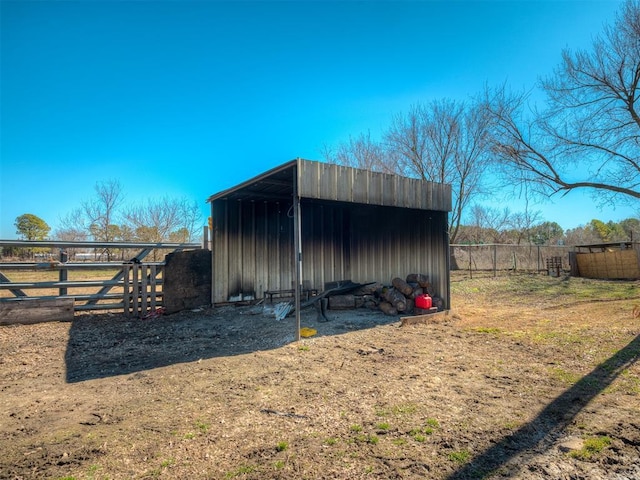 view of outbuilding with an outbuilding and fence