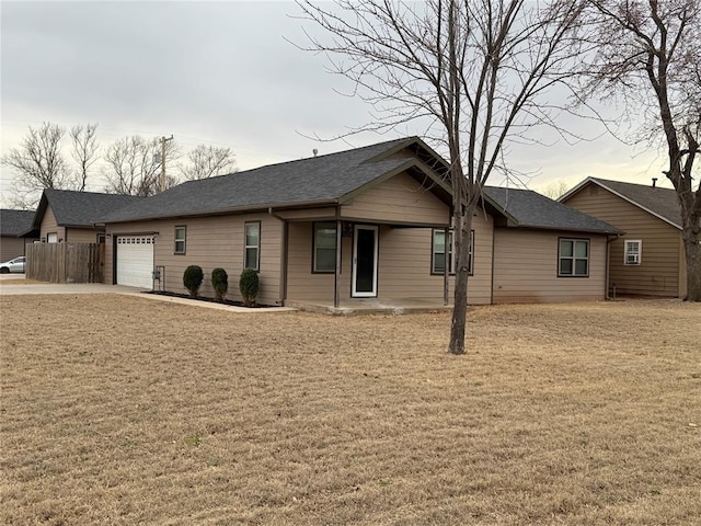 single story home with a garage, a front yard, and fence