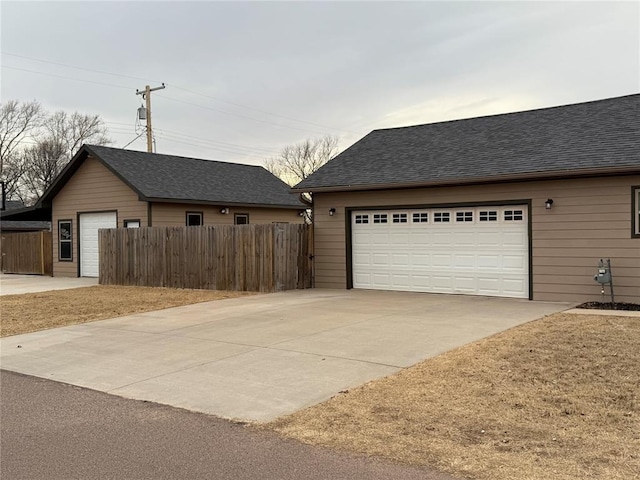 view of front of property with a shingled roof and fence