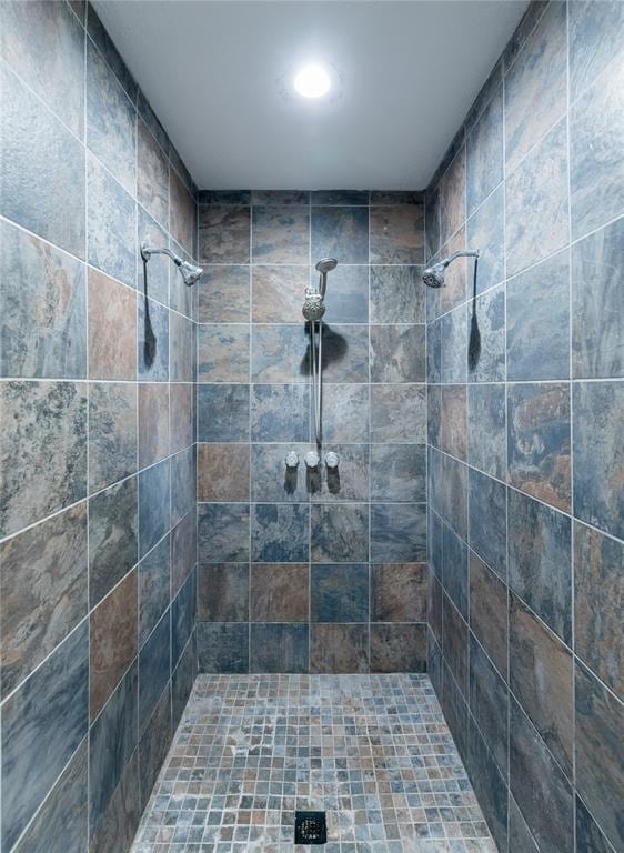 bathroom with a tile shower