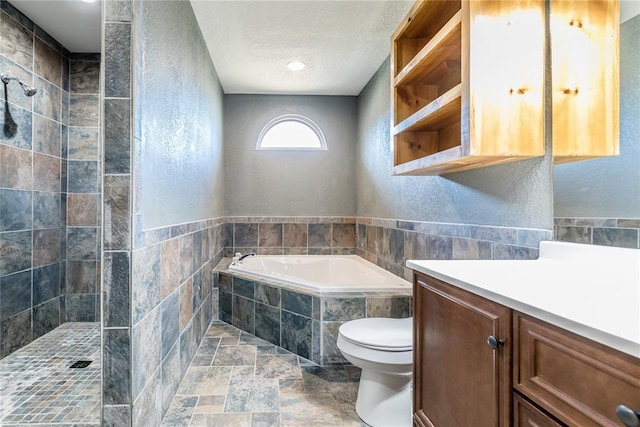 full bathroom with a textured wall, tiled shower, a garden tub, and a textured ceiling