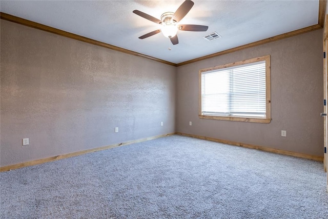 unfurnished room with ceiling fan, a textured wall, carpet floors, visible vents, and ornamental molding