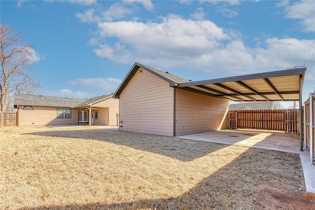 exterior space featuring a carport and fence