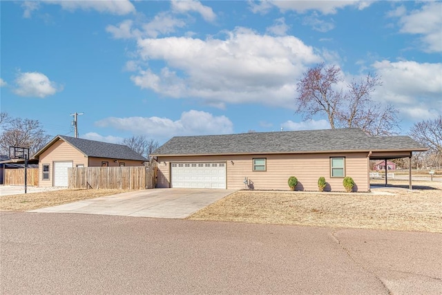 single story home with concrete driveway and fence