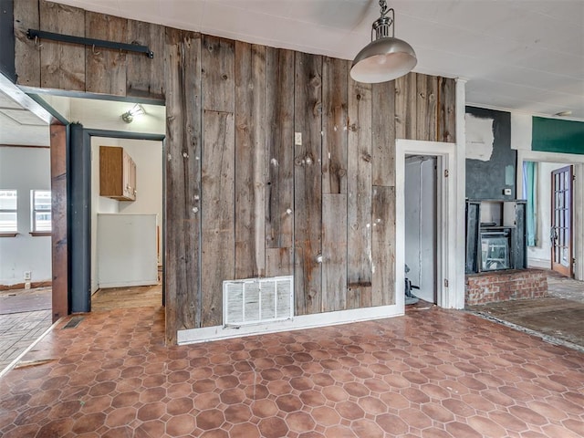 interior space featuring wooden walls and visible vents