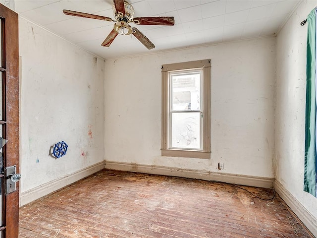 empty room with hardwood / wood-style flooring and a ceiling fan