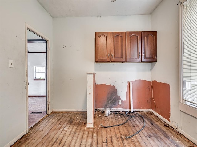 interior space featuring hardwood / wood-style flooring and baseboards