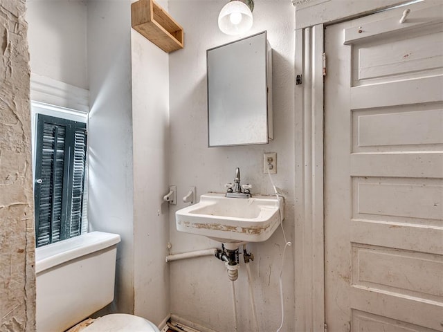 half bath with a sink and toilet