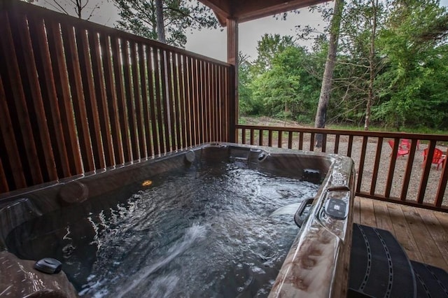 wooden terrace featuring a hot tub