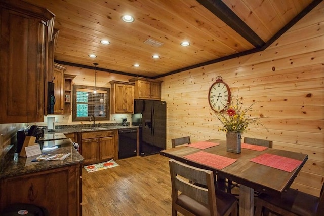 kitchen with black appliances, wood walls, wooden ceiling, and recessed lighting