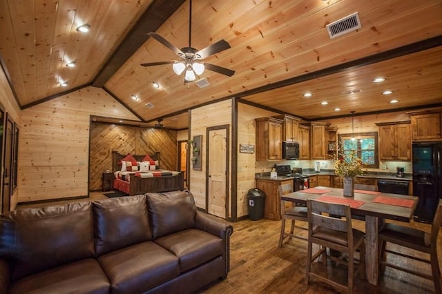 living room featuring wood ceiling, wood walls, and visible vents