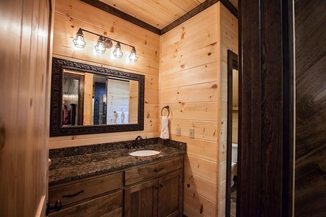 bathroom featuring wooden ceiling, wood walls, and vanity