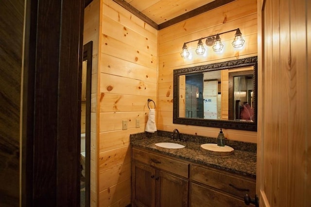 bathroom with wood walls and vanity