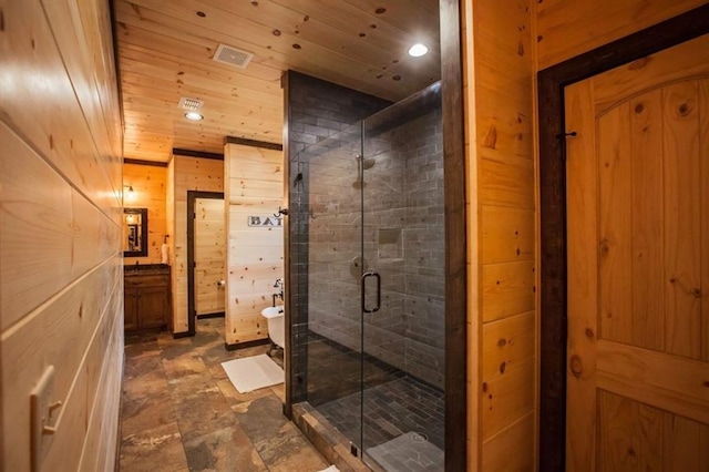 full bathroom featuring a stall shower, wooden ceiling, visible vents, and wooden walls