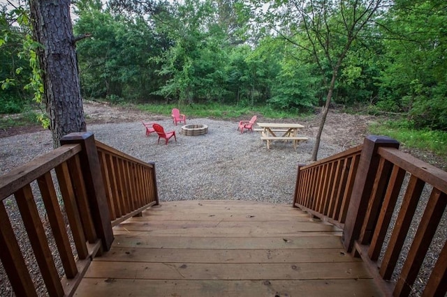 wooden terrace featuring a fire pit