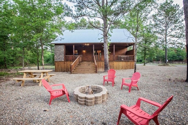 exterior space featuring a fire pit and covered porch