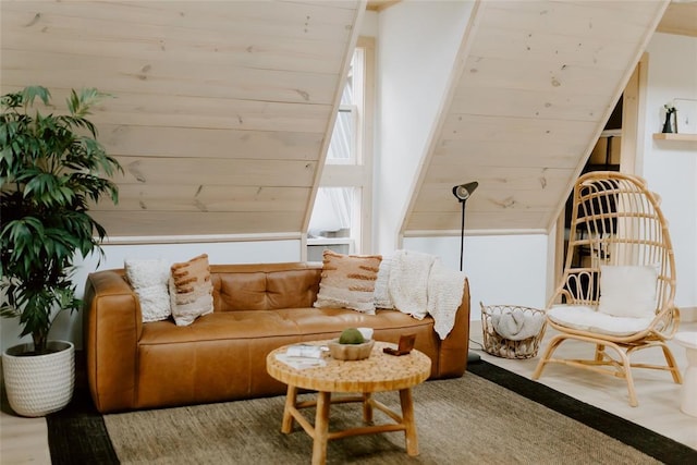 living area featuring lofted ceiling and wood finished floors