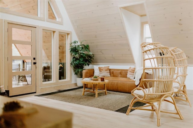 sitting room featuring vaulted ceiling, wooden ceiling, wood finished floors, and wooden walls