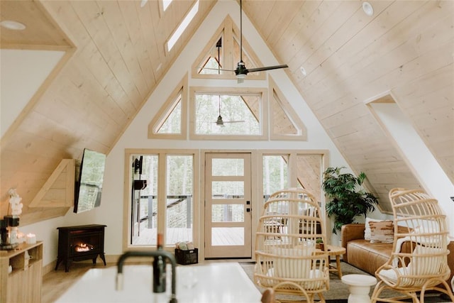 interior space with wooden ceiling, high vaulted ceiling, and a ceiling fan