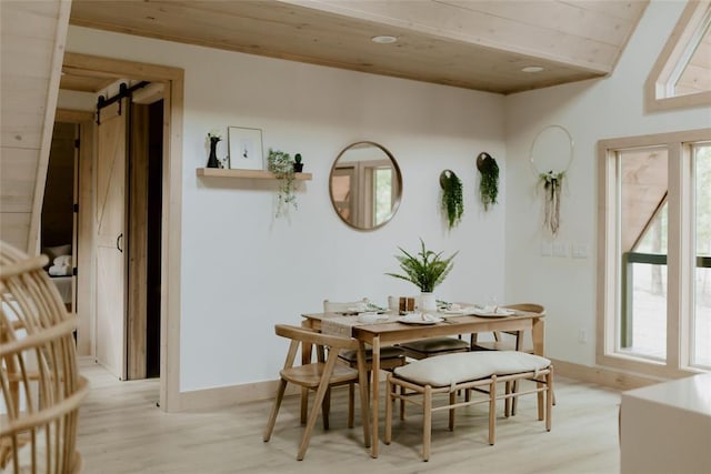 dining area featuring a barn door, baseboards, wooden ceiling, light wood-type flooring, and recessed lighting