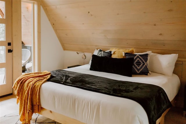 bedroom featuring wooden walls and vaulted ceiling