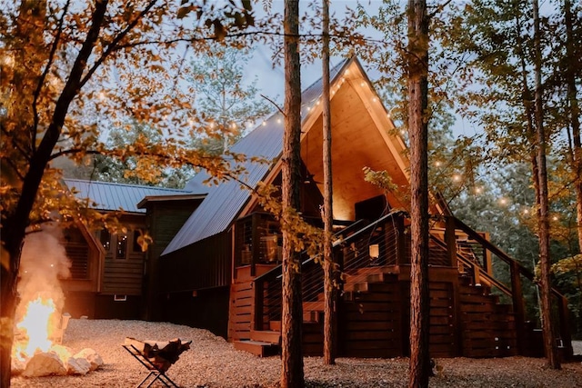 view of home's exterior with stairs and metal roof