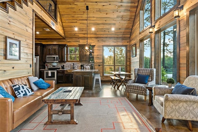 living room featuring a high ceiling and wooden walls