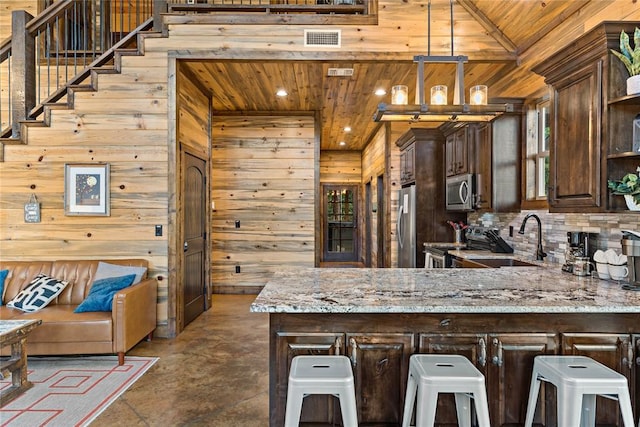 kitchen with wooden ceiling, visible vents, appliances with stainless steel finishes, and a sink