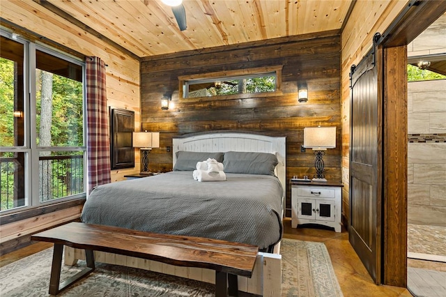 bedroom featuring wood ceiling, a barn door, wooden walls, and multiple windows