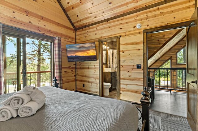 bedroom with access to exterior, lofted ceiling, ensuite bathroom, wood ceiling, and wooden walls