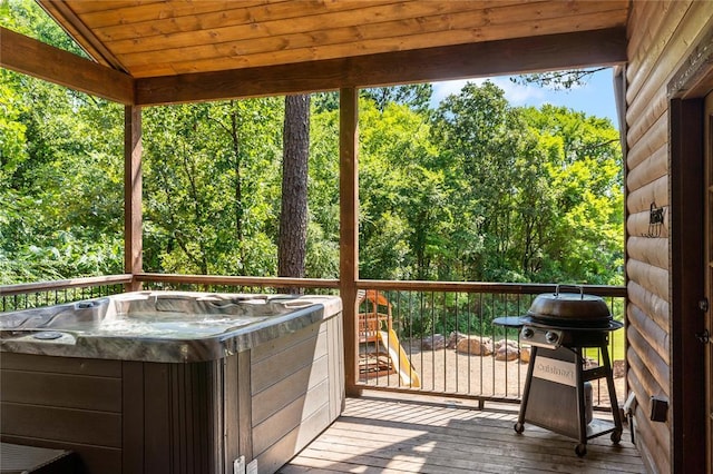 wooden deck featuring a hot tub and grilling area