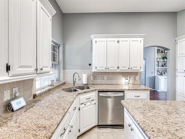 kitchen with white cabinets, a sink, and stainless steel dishwasher