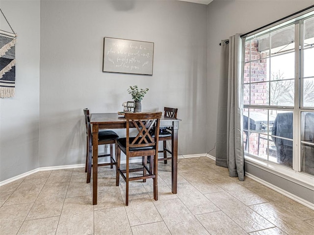 dining room featuring light tile patterned floors and baseboards