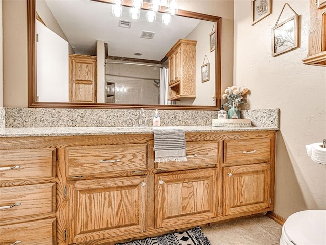 full bathroom featuring toilet, visible vents, and vanity