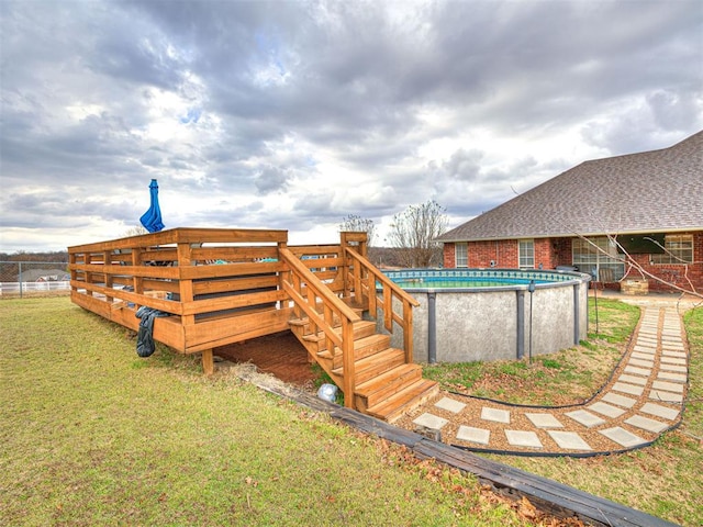 view of yard featuring an outdoor pool and a wooden deck