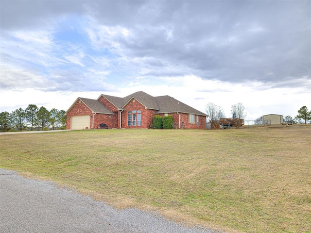 ranch-style house with a garage, a front lawn, and brick siding