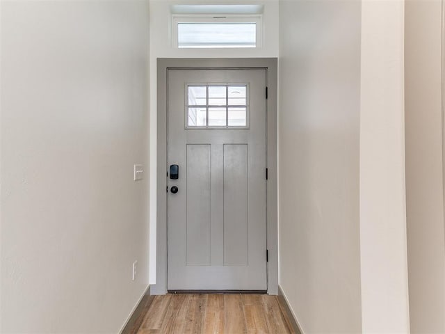 entryway with light wood-style flooring and baseboards