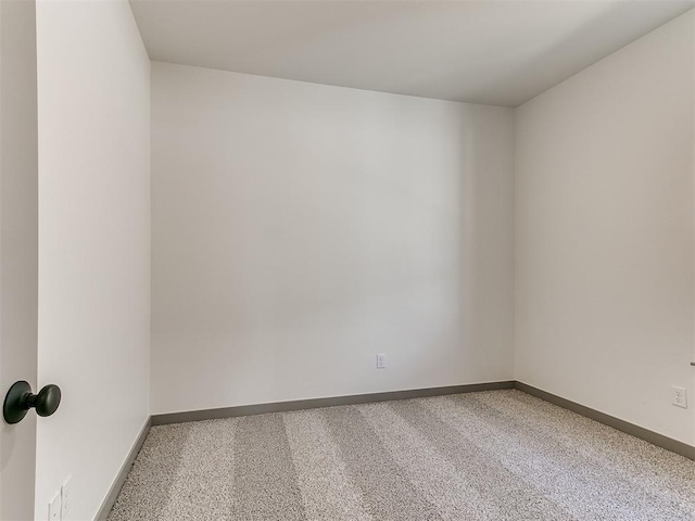 unfurnished room with carpet floors and baseboards