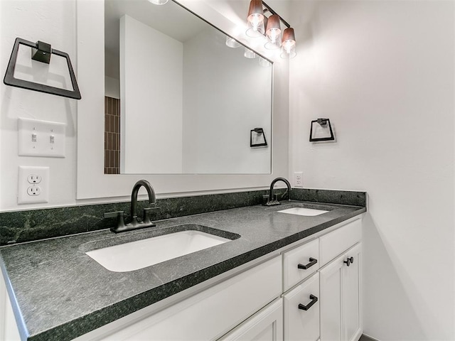 full bathroom with a sink and double vanity