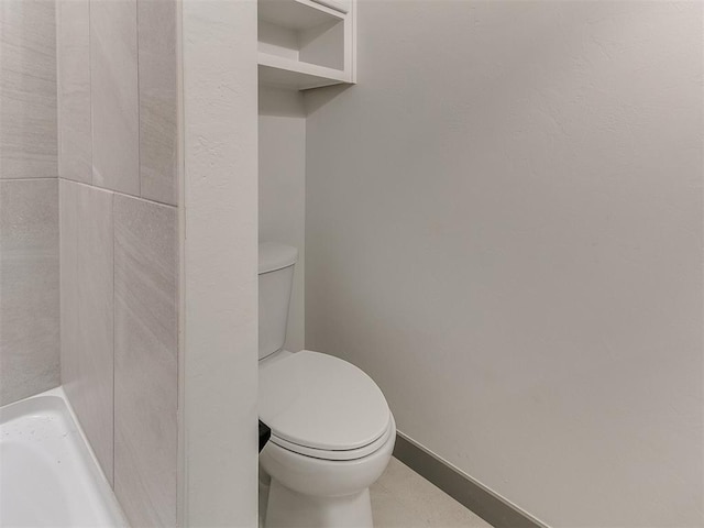 bathroom with toilet and baseboards