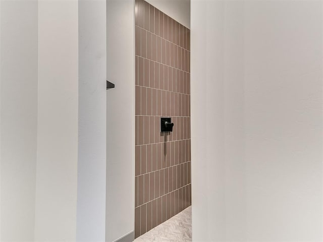 bathroom with a tile shower