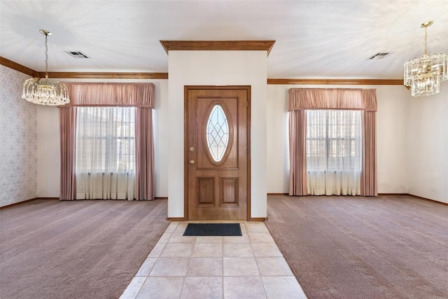 entryway with a chandelier, light colored carpet, and crown molding