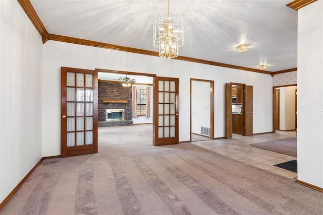 interior space featuring carpet floors, french doors, a fireplace, ornamental molding, and baseboards