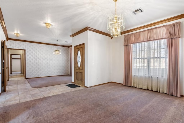 foyer featuring light carpet, visible vents, ornamental molding, wallpapered walls, and an inviting chandelier