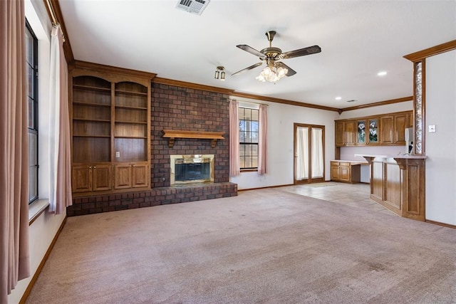 unfurnished living room featuring light colored carpet, visible vents, baseboards, ornamental molding, and a brick fireplace